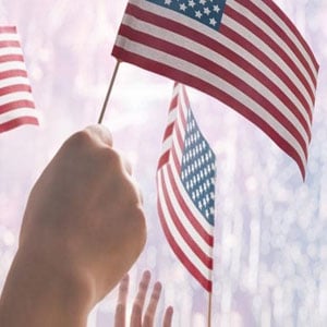 People holding American flags - Driggs Immigration Law
