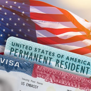 Green card in front of American flag - Driggs Immigration Law