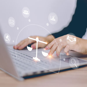 Woman using laptop with justice icon on screen, symbolizing legalization. - Driggs Immigration Law
